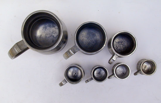 An Assembled Set of Enlish Pewter Bellied Pub Measures