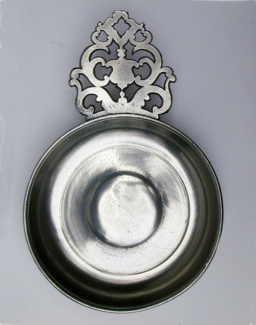 An Unmarked Flower Handle Porringer Attributed  to the Shop of David Melville