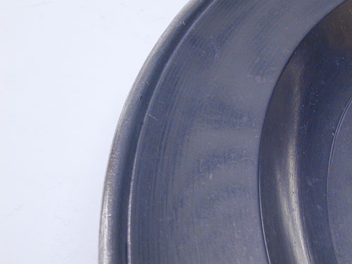 A Stephen Barnes Single Reed Rim Pewter Plate