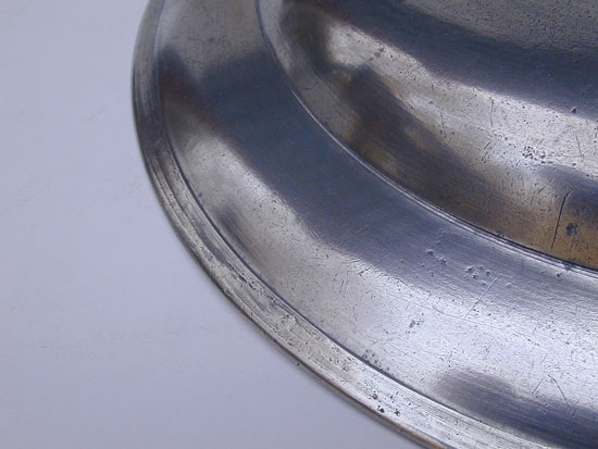 A Stephen Barnes Single Reed Rim Pewter Plate