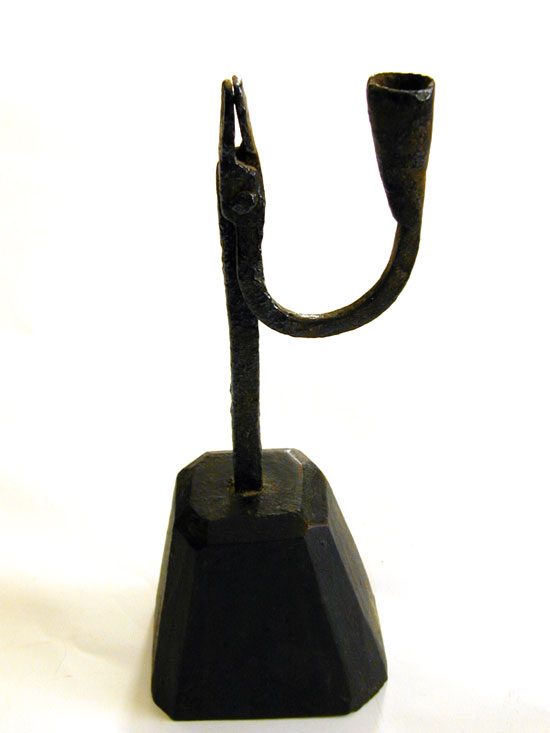 A Wrought Iron Rush And Candle Holder